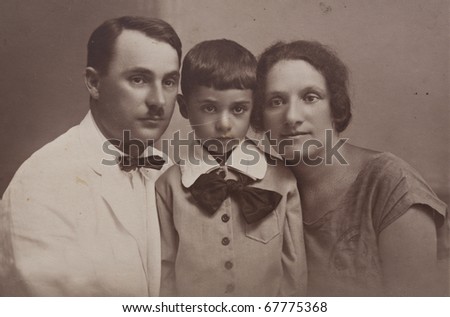 Family portrait of a young couple with a child, an old picture