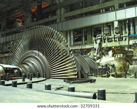 steam turbine during repair, machinery, pipes, tubes at a power plant, night scene