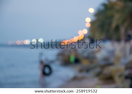 Blur background of people in the sea in evening with bokeh.