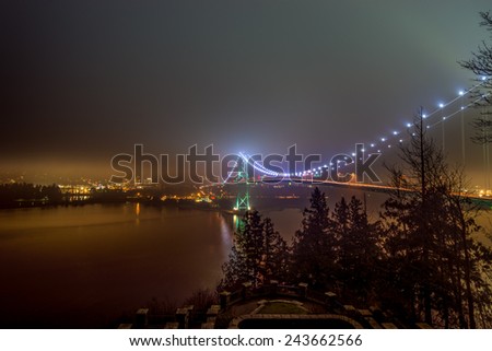 Lions Gate bridge with skyline covered in fog in Vancouver, British Columbia, Canada