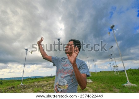 Similar – Image, Stock Photo Rotating windmill generating renewable energy wind power at land