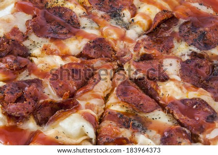 A mouthwatering closeup of a pepperoni pizza pie cut into slice