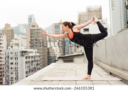 Asian Girl doing Yoga on a Rooftop in Hong Kong