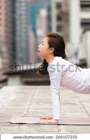 Asian Girl doing Yoga on a Rooftop in Hong Kong Island