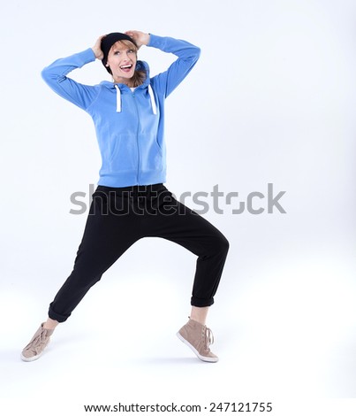 Young beautiful woman in comfortable clothes exercising, smiling. Healthy lifestyle.