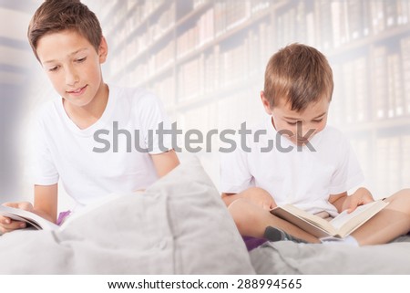 Little brothers reading a books. Family photo.