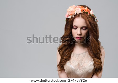 Beautiful girl with red hair and flowers