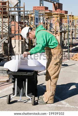 Worker Studying the Blueprints