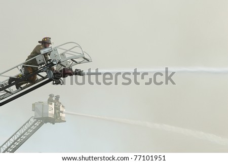 DAYTON, OHIO - AUGUST 15: Firemen on duty battle a warehouse fire from aerial ladders on August 15, 2008 in Dayton, Ohio, USA.