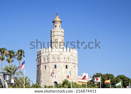 La Torre de Oro (Tower of Gold) with some flags. Seville, Andalusia, Spain.