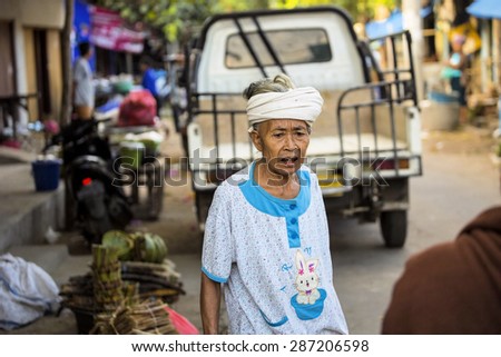 PENIDA ISLAND, INDONESIA - JUNE 13.2015: old  woman at the market. Nusa Penida June 13.2015 Indonesia