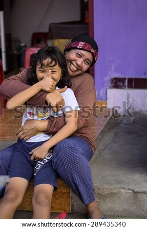 PENIDA ISLAND, INDONESIA - JUNE 22.2015:  woman Muslim with chidren at the market, village Toyopakeh, Nusa Penida June 22. 2015 Indonesia