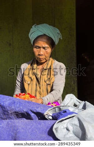 PENIDA ISLAND, INDONESIA - JUNE 22.2015:  old woman Hindu at the market, village Toyopakeh, Nusa Penida June 22. 2015 Indonesia