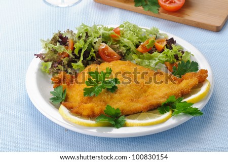 Chicken cutlet with vegetables in white dish