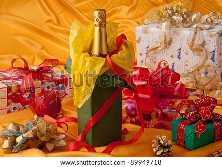Bottle of sparkling wine and Christmas gift packages