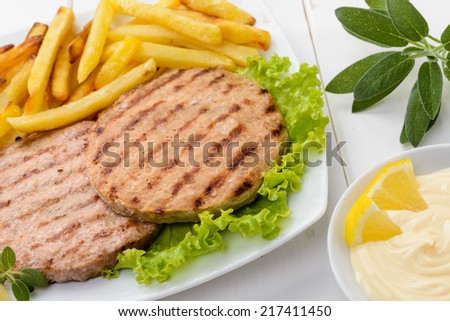 Hamburger with fries and mayonnaise