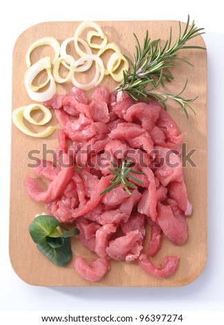 Beef cut into strips on a wooden board