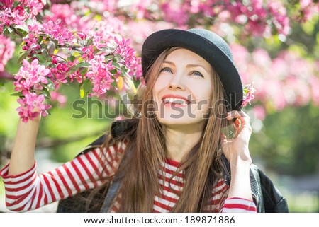 Beautiful sunny portrait of a girl. Face laughing girl in spring park