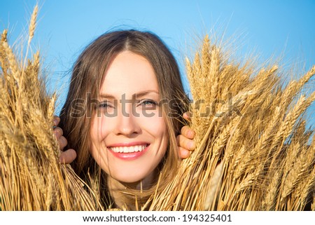 Alluring young woman in wheat field,  sensual happy woman on nature. perfect skin, hair