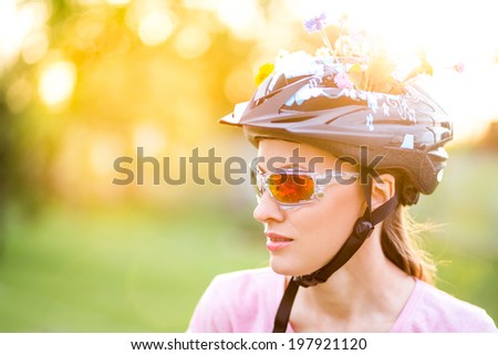 Portrait of young cyclist in glasses and helmet on a sunny summer day. Fun, sun and ride concept. soft sunlight, focus on glasses and face, backlit