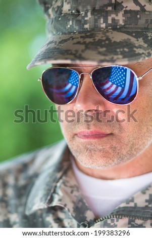 Proud us army soldier with american flag in sunglasses reflection