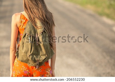 Back of young hipster woman with backpack. focus on backpack