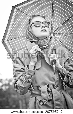 Black and white portrait beautiful girl in the rain with umbrella
