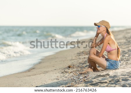 Smiling happy young woman enjoying serene ocean nature during travel holidays vacation outdoors