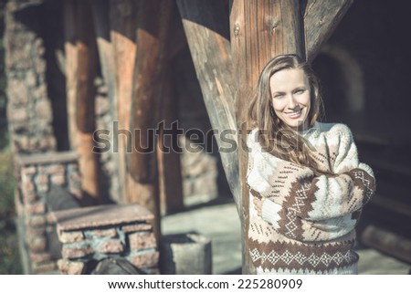 beautiful girl enjoying the freshness of the new day in old wooden chateau. toned image