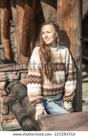 beautiful girl enjoying the freshness of the new day in old wooden chateau