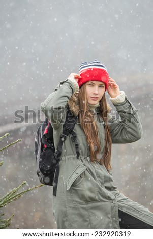 Young traveler enjoy the freshness of winter nature and first snow. copy space