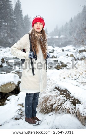 portrait of adventure woman  in snowy mountains