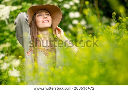 Happy woman in summer field. Young girl relax outdoors. Freedom concept