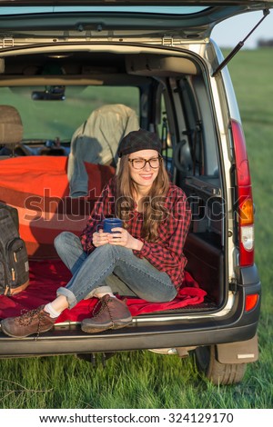 Freedom car travel concept - woman relaxing in a car. Girl relaxing enjoying free holidays road trip