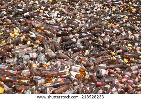 Bangkok, Thailand - 15 May 2014:  Mountain of used glass bottles in a recycling plant  May 15,  2014 in Bangkok. The used glass was collected in containers and will be crashed for recycling.