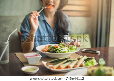 Closeup of a woman eating healthy salad . Beautiful smiling woman eating healthy salad. ストックフォト © 