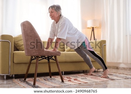 Similar – Image, Stock Photo Senior woman exercising at home