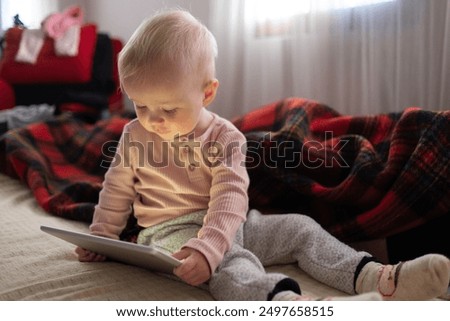 Similar – Image, Stock Photo Toddler playing with a colorful plastic bug toy; using hands to manipulate small object developmental milestone