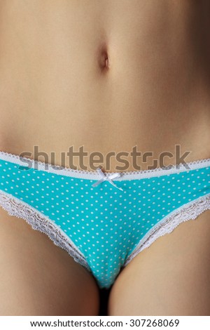 Women lean belly with blue panties. A healthy diet and proper way of life
