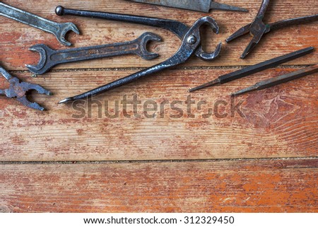 Older tools are laid out on top of picture on background of the old wooden floor