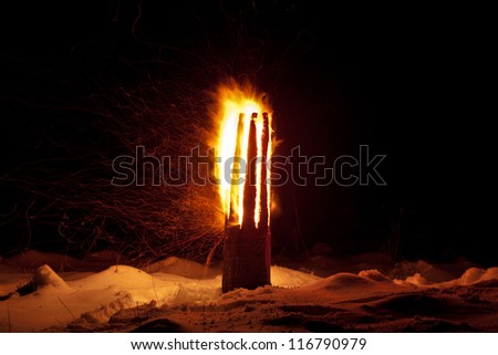 Winter solstice pagan traditions in Latvia. Yule log burning ritual. The ritual is symbolic of joint effort to combat the power of darkness and to turn toward the light once again.