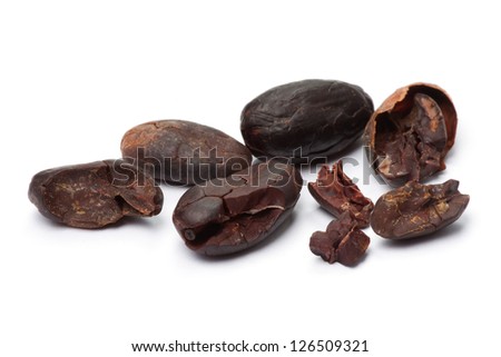Cacao beans isolated on white background. Shallow depth of field.