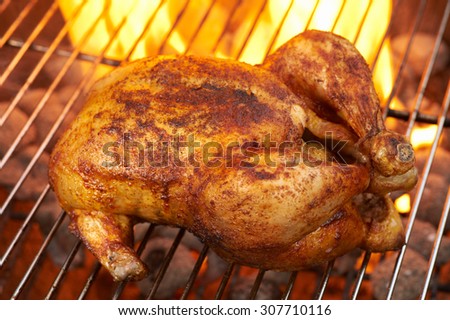 Chicken on BBQ Grill flames in the background