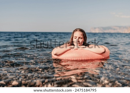 Similar – Image, Stock Photo Young happy woman swimming in the sea in sunset