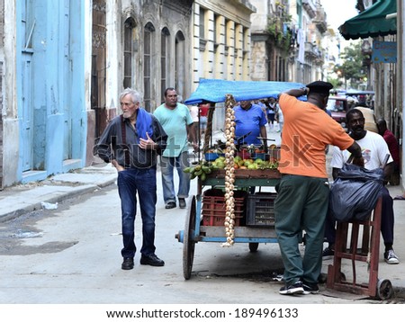 HAVANA, CUBA - DECEMBER 9: A vegetable seller with its cart serving the customers in Havana, Cuba on December 9, 2013