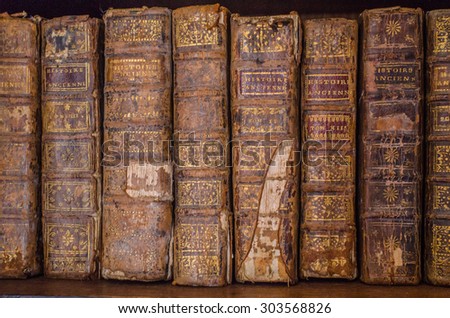 PAU, FRANCE - JULY, 19: A pile of old ancient books in the dark room in Pau, France on 19 July, 2015