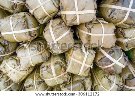 Food in banana wrapping (after being steamed , the banana leaf will change color to be like brown and green , not colorful as fresh on the tree) and these are steam sausage in Thailand.