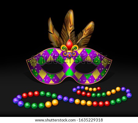 Masquerade mask, beads, multicolored feathers on a dark background