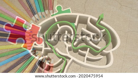 Image of puzzles falling over human brain with maze and colour pencils on grey background. autism and learning difficulties awareness and support concept digitally generated image.