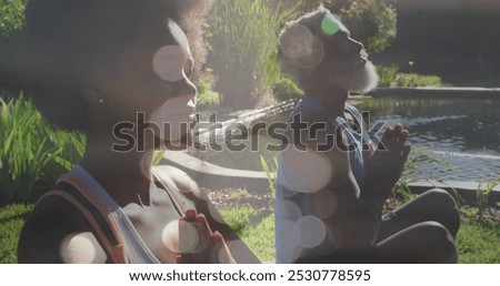 Similar – Image, Stock Photo Focused couple doing yoga in Awkward pose in park